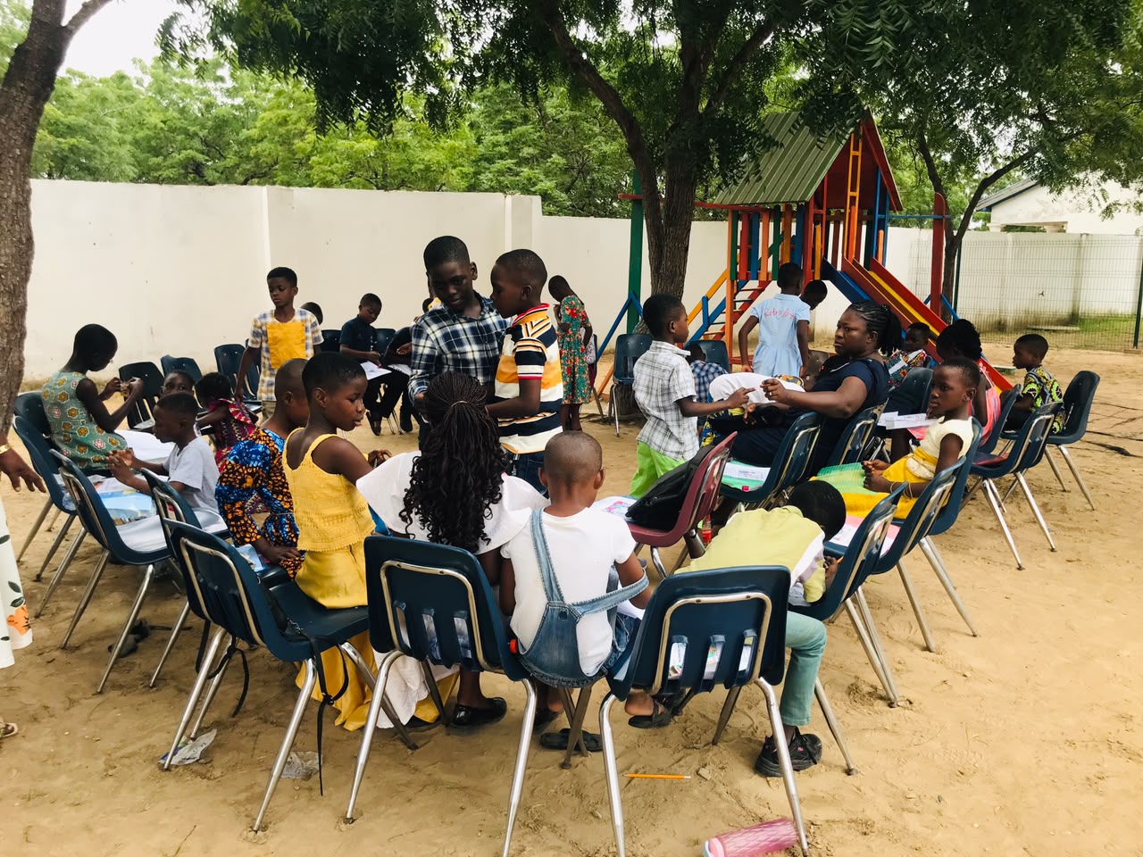 Children and adults taking part in an outdoor school community activity