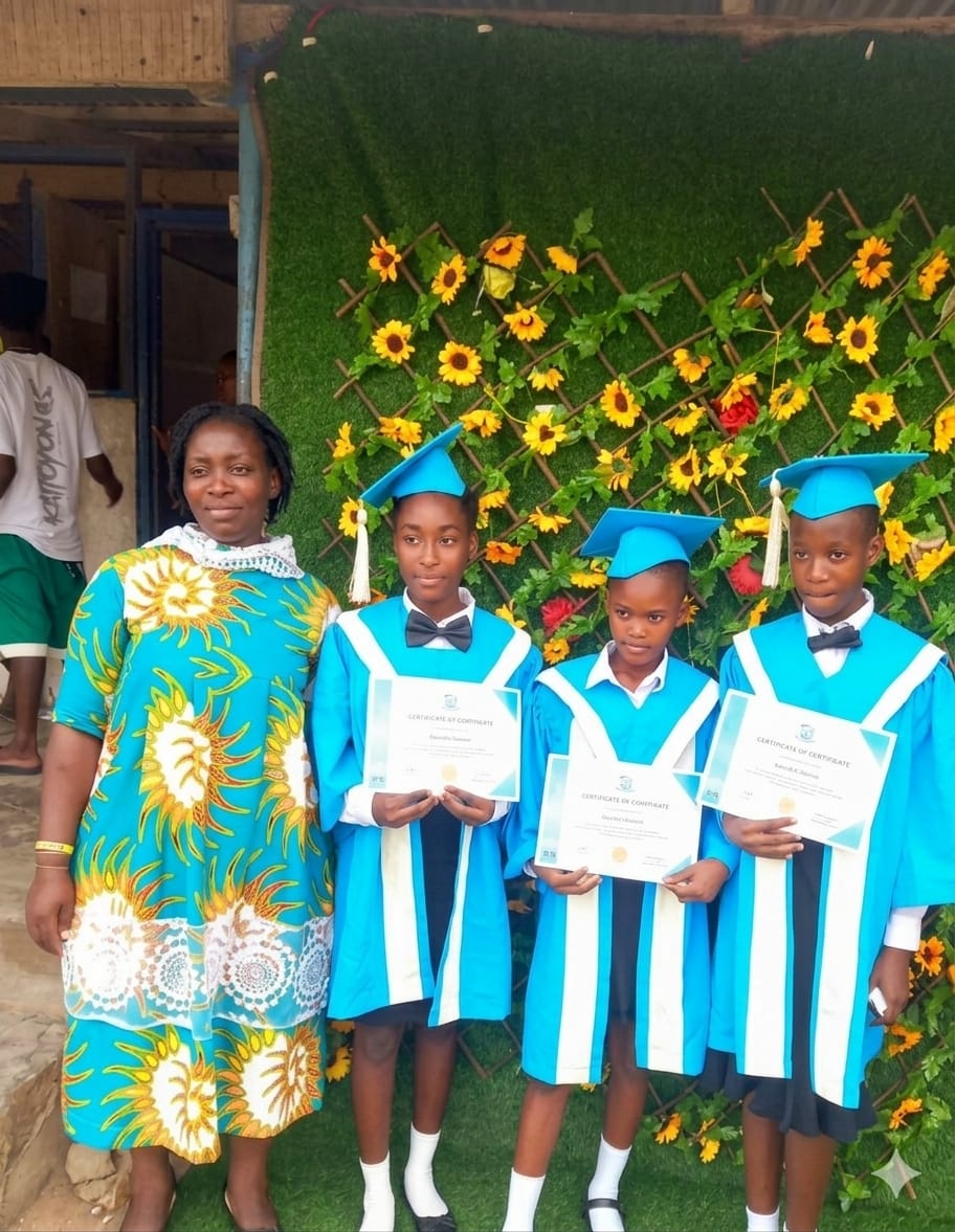 ROSA graduates in blue gowns holding certificates