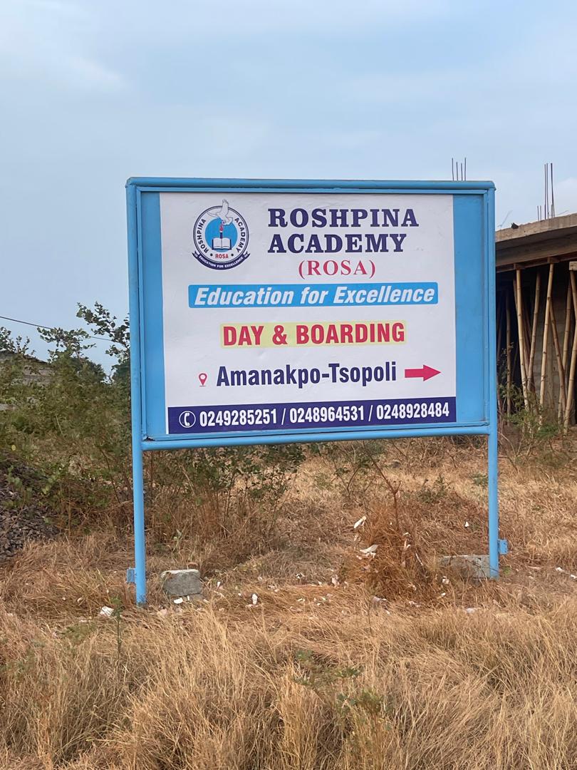 Roshpina Academy roadside sign showing the Amanakpo-Tsopoli location